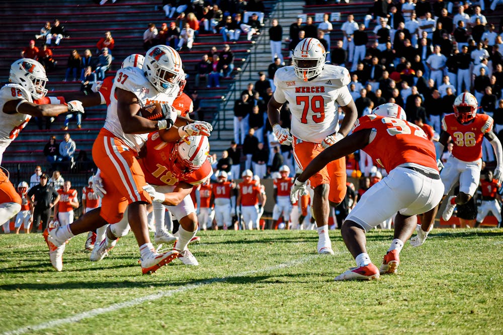 <p>CJ Miller (#37) breaks through a tackle in the game against VMI on Saturday, Oct. 29. Miller had a touchdown in the third quarter and gained 105 rushing yards in the game. The Bears won 55-14, bouncing back from last week&#x27;s loss against Chattanooga.  Photo provided by Mercer Athletics.</p>