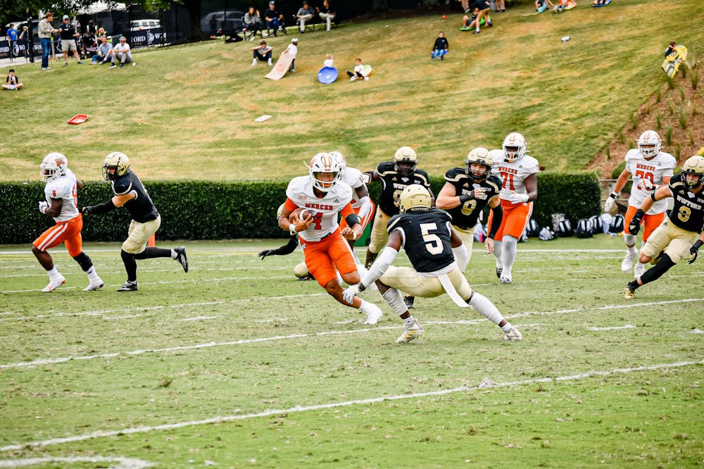 <p>Quarterback Fred Payton (#4), runs the ball down the middle of the Wofford defense. Payton rushed for 27 yards and threw for 330 yards with an 83% completion rate. The Bears defeated the Terriers 42-7 to claim their third win in a row. Photo by Abby Sugg. </p>