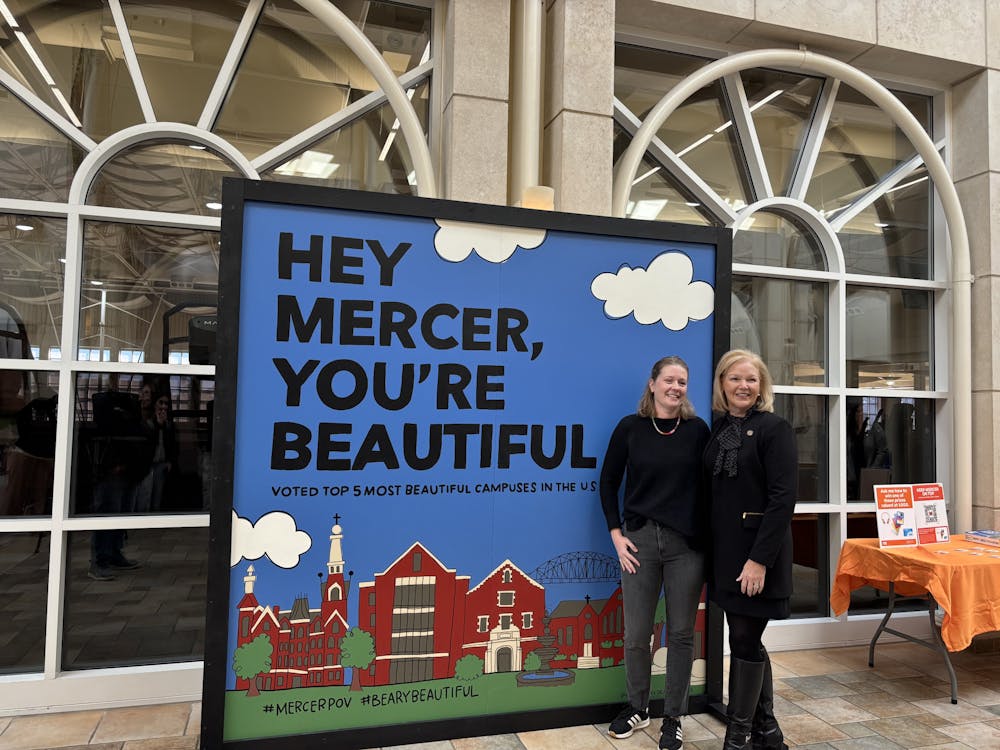 <p>Erin Hawkins (left) and Penny Elkins (right) pose in front of the new mural in the University Center following a mural unveiling ceremony on Thursday, Jan. 9, 2025. </p>