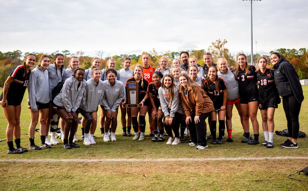 The women's soccer team poses with the SoCon runner-up trophy after their loss against Samford University on Nov. 9.