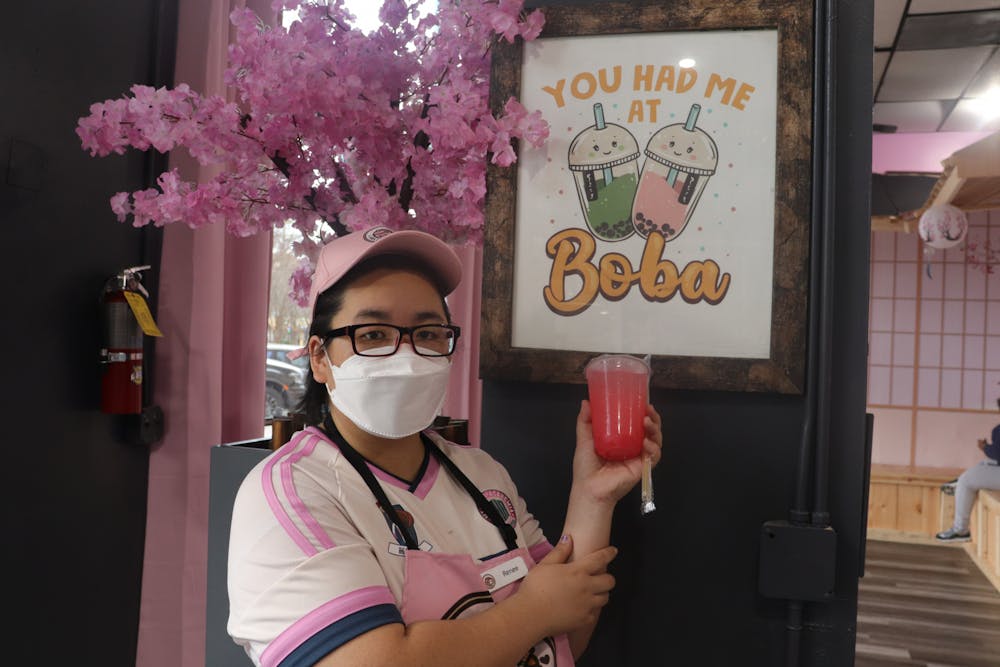 <p>Hello Boba Cafe owner Renee Tu poses for a portrait holding the Cherry Blossom Special Shimmering Sakura Lemonade in her store on March 18, 2022.</p>