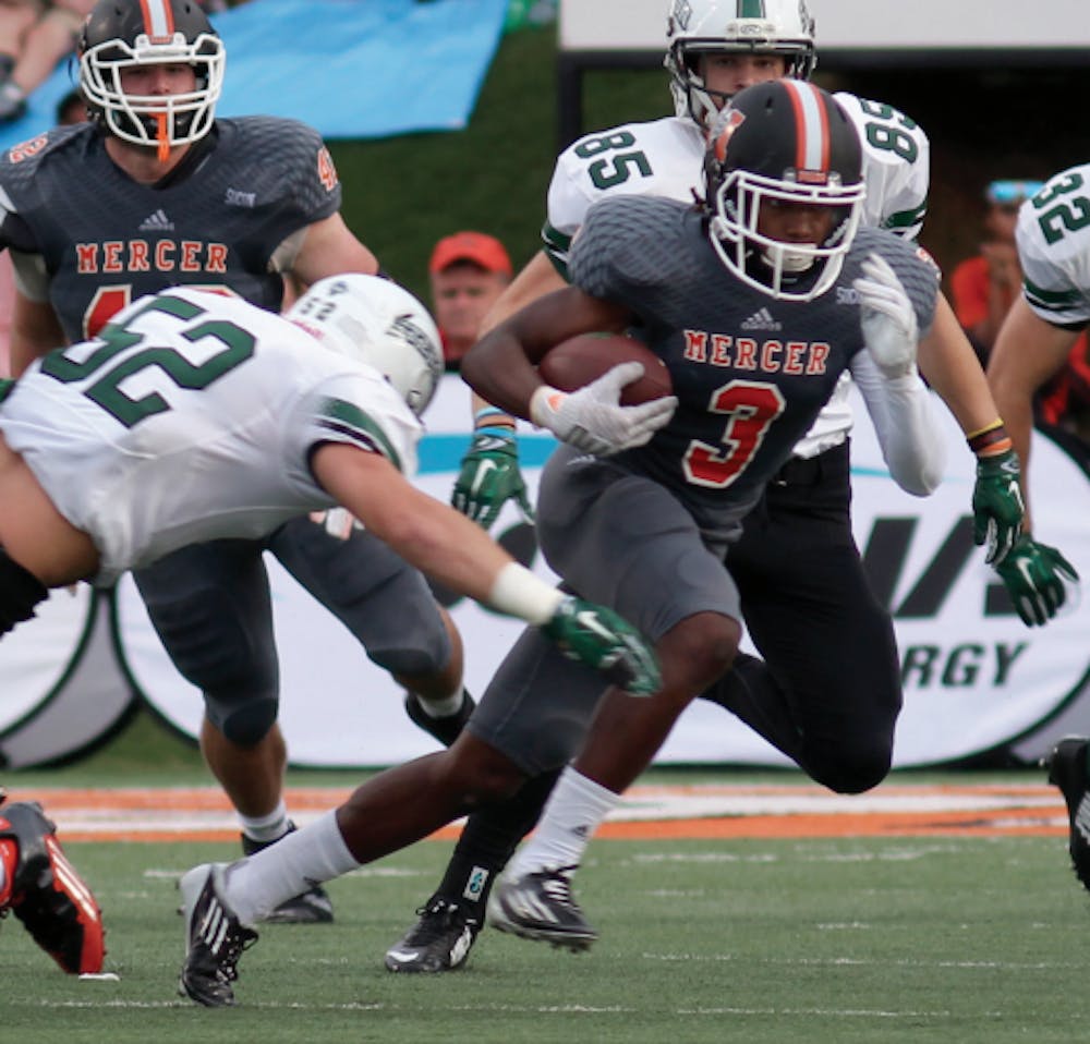 Stetson’s Kimo Vereen (20) dives to tackle Mercer’s Stephen Houzah (3) in their game on Sept. 12.