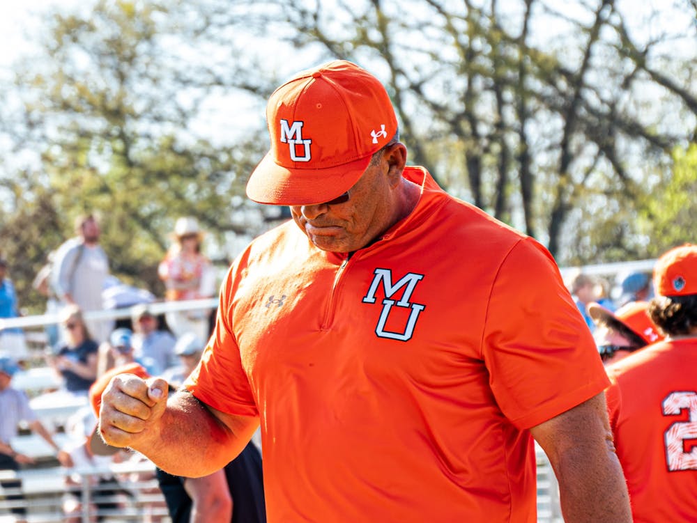 <p>Mercer head baseball coach Craig Gibson pumps his fist. ﻿</p>