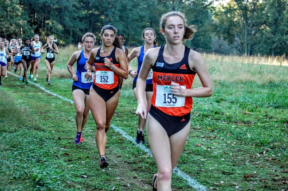 <p>Mercer cross country runners Laney Doster (#155) and Giulia Giorgi (#152) running in the NCAA regional tournament. Photo provided by Mercer Women&#x27;s Cross Country.</p>