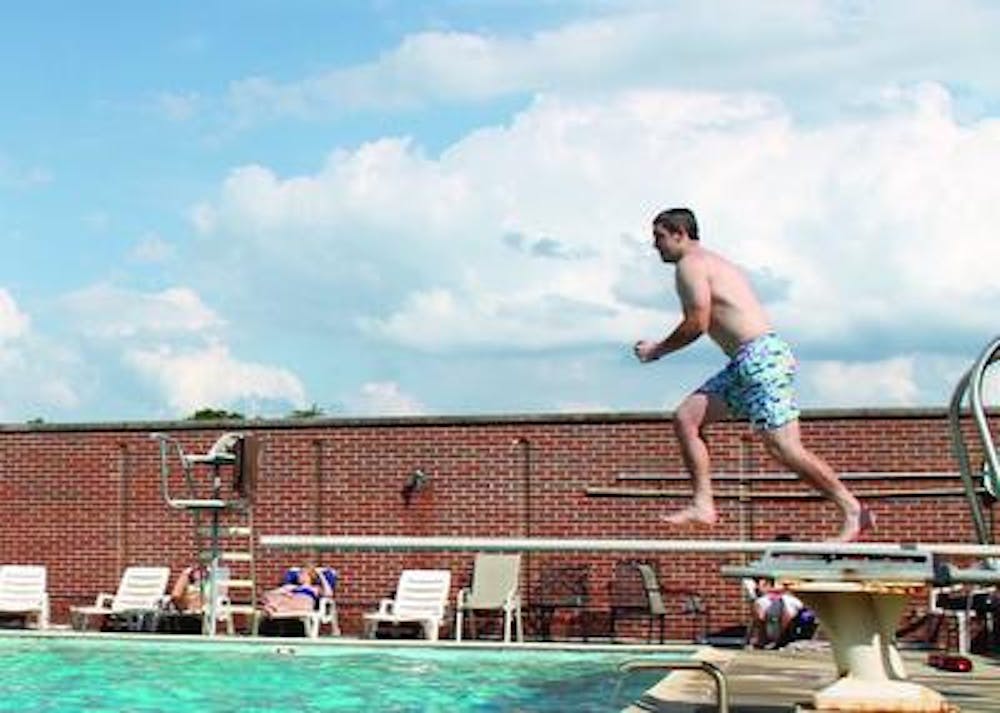 Students lounge around The Plunkett pool before finals week begins.