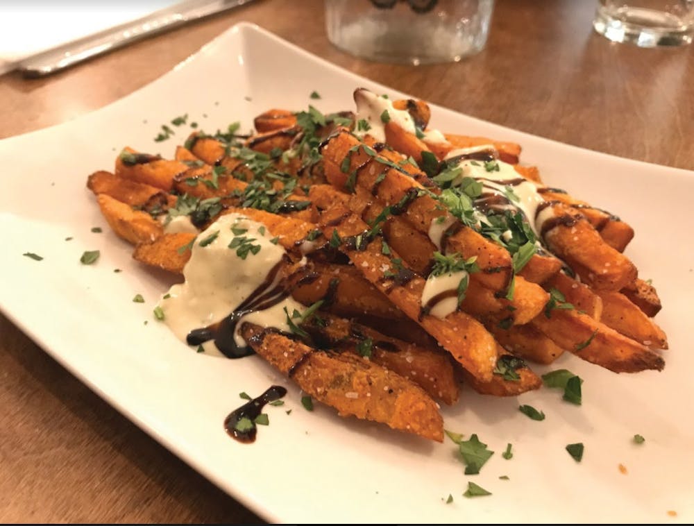 The sweet potato frites are topped with balsamic vinegar and bleu cheese cream. 