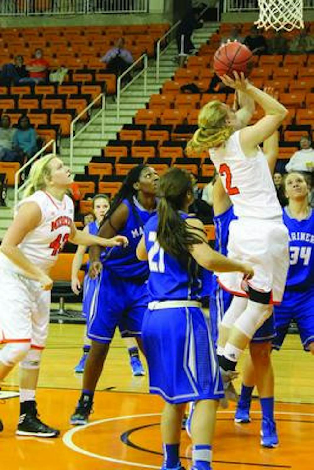 Mercer Bear’s Amanda Thompson, 2, jumps up to shoot a basket in their game against the Coastal Georgia Mariners.