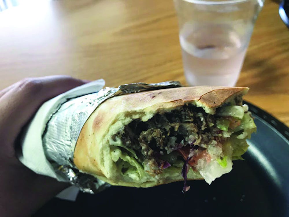 The lamb and beef shawarma wrap includes tzatziki sauce, lettuce, tomatoes, and purple cabbage. Photo by Peter Garcia.
