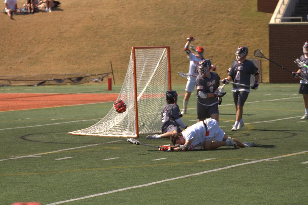 <p>Mercer Bears&#x27; #51 Taylor Dooley recovers from a helmet launching tackle after scoring his team&#x27;s second goal in the second period.</p>