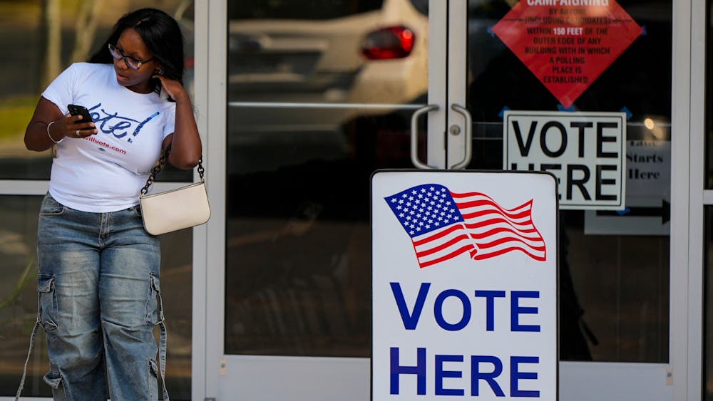 A woman leaves a voting center after voting, Tuesday, May 19, 2026, in Marietta, Ga. (AP Photo/Mike Stewart)