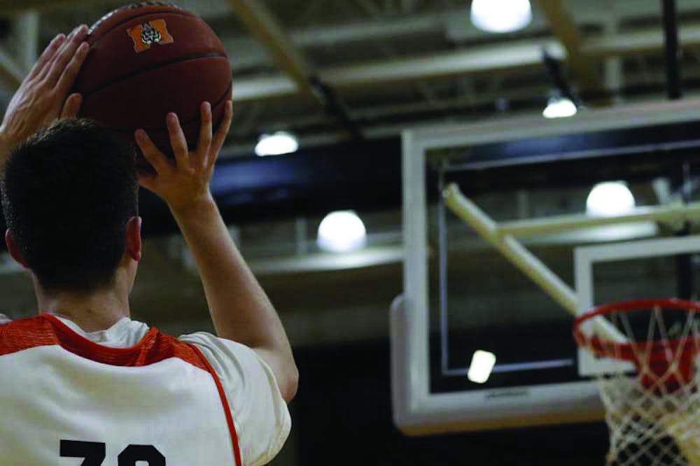 Ross Cummings (#20) practicing his jump shot for the upcoming Orange & White Tip Off Game.
Photo by Yusuf Tas. 