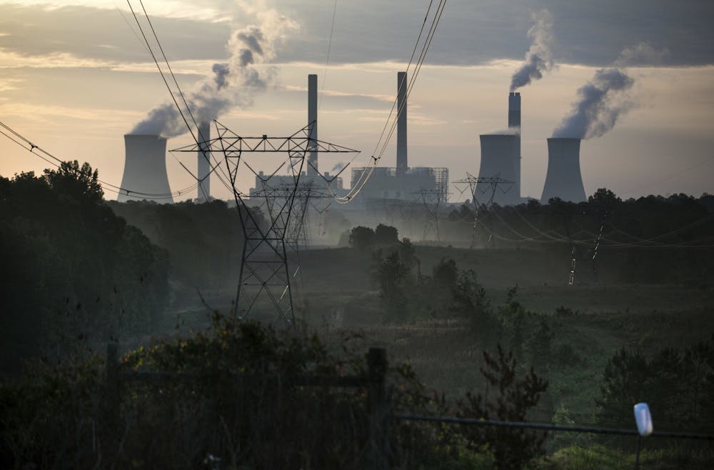 The coal-fired Plant Scherer, one of the nation's top carbon dioxide emitters, stands in the distance in Juliette, Ga., Saturday, June, 3, 2017. The plant is increasingly used to fuel power-hungry data centers in the state. (AP Photo/Branden Camp)
