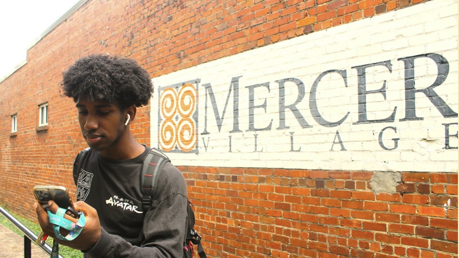 Michael Williams &#x27;23, a communications and media studies major, chooses his next song on his way to class.