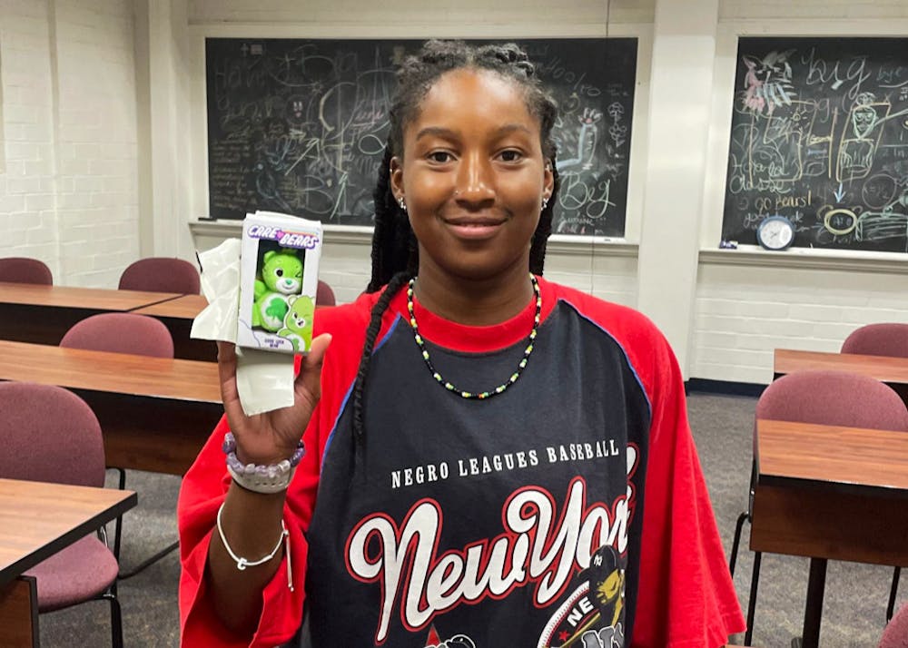 Jayla Battle ‘29 poses with the green care bear she recovered from underneath a desk at the Bear Hunt on Sept. 26.