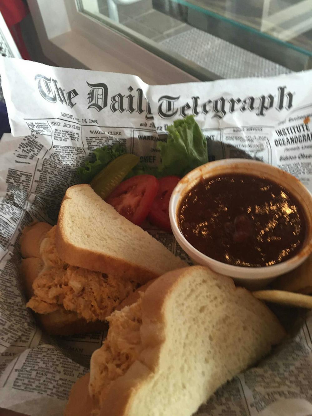 Molly's Red Rooster Cafe serves its sandwiches The sandwiches in cutout sheets meant to resemble a page of the Telegraph, the daily British newspaper. 