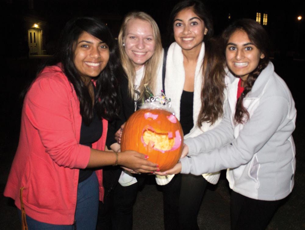 Friends show off their princess pumpkin for the homecoming competition.