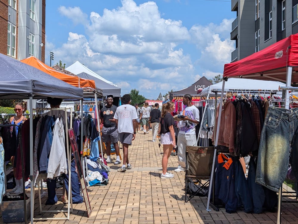 <p>Shoppers browse vendor tents to look for vintage clothing at the Macon Vintage Market on Friday, Sept. 5.</p>