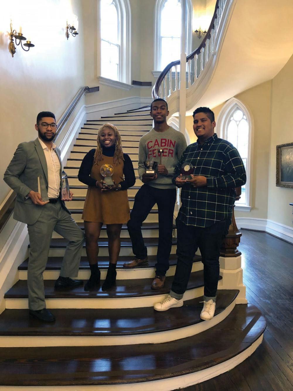 Kyle Bligen, Jaz Buckley, Keanu Lowo and Daniel Alvarez pose for the camera after their big debate win at the 12th Annual Mile High Swing. 