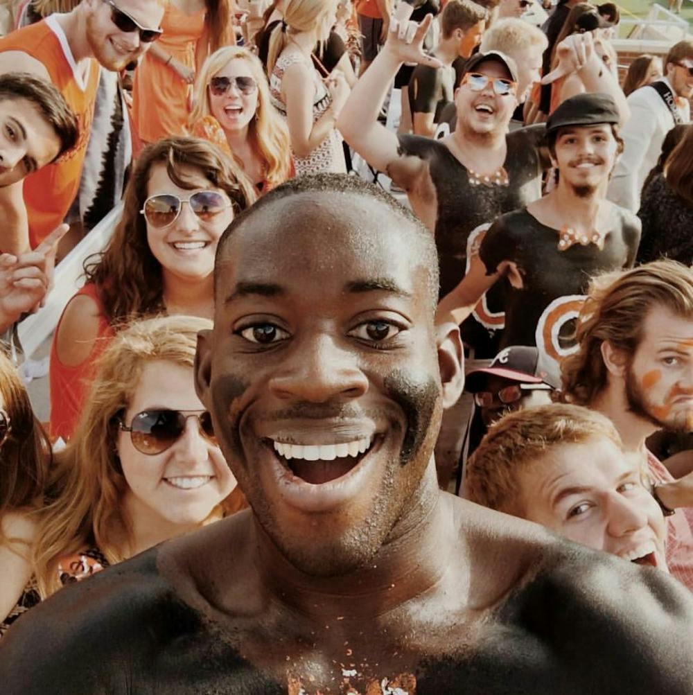 Special Photo "Hype Man Sam" Osakue, junior, poses with fellow Mercer Maniacs on game day after painting up.