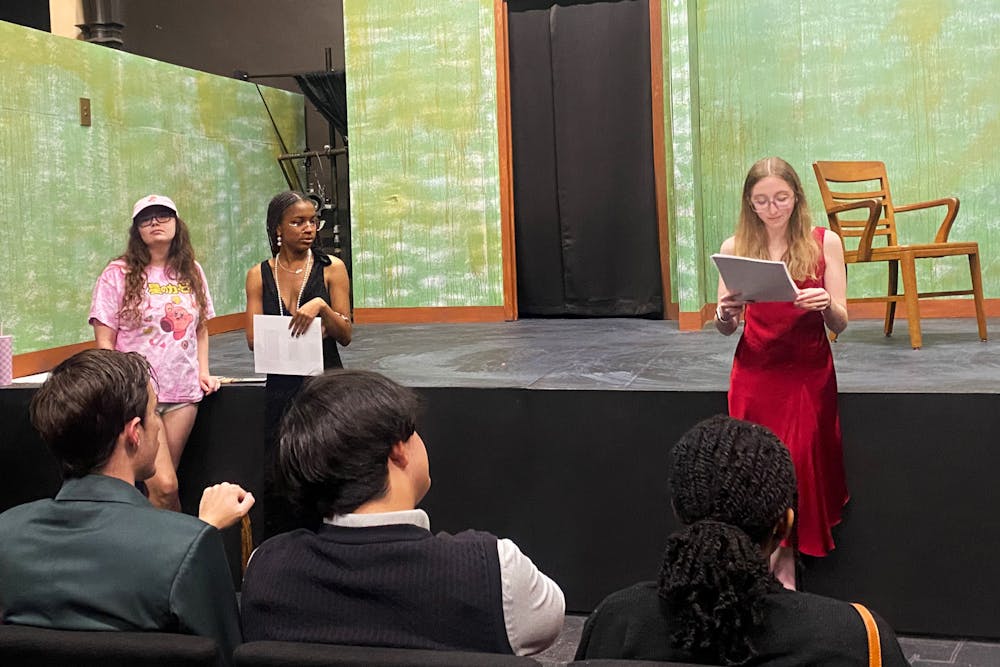 Mercer Players President Danica Dilione ‘27 read character roles aloud to Murder Mystery attendees on Nov. 4.