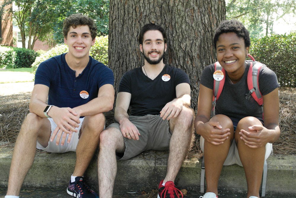 From right to left: Brady Simon, John Williams,and Gabrielle Sims bear their sophomore buttons.