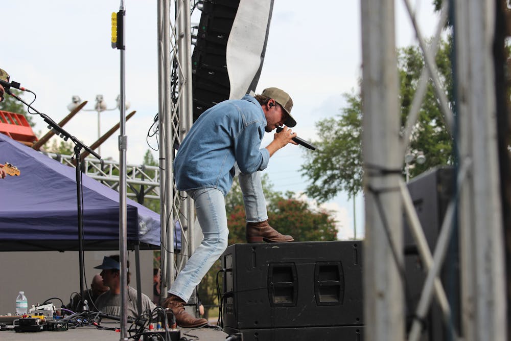 Conner Smith performs on Black Field during the Ford Concert Series tailgate event on Aug. 29. Smith performed a variety of songs, including originals and covers.