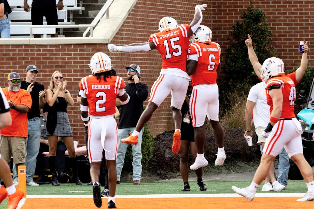 Marques Thomas '25 and Ken Standley '25 celebrate after Thomas returned an interception for his first career collegiate touchdown in a 38-31 win against East Tennessee State University on Saturday.