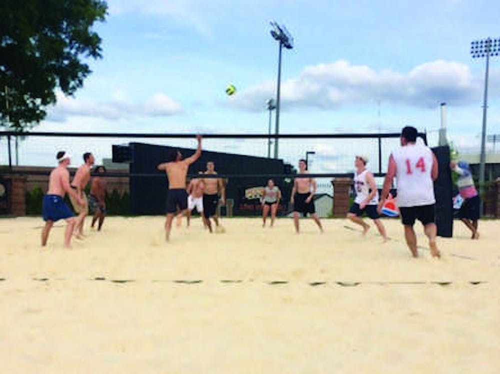 Football player Mitch Payne plays in a SAE Philanthropy Volleyball Tournament alongside teammates.