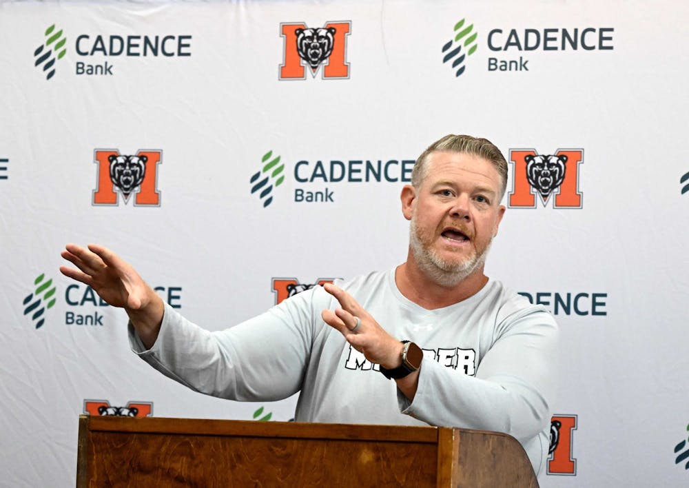 Football head coach Mike Jacobs speaks at a press conference.