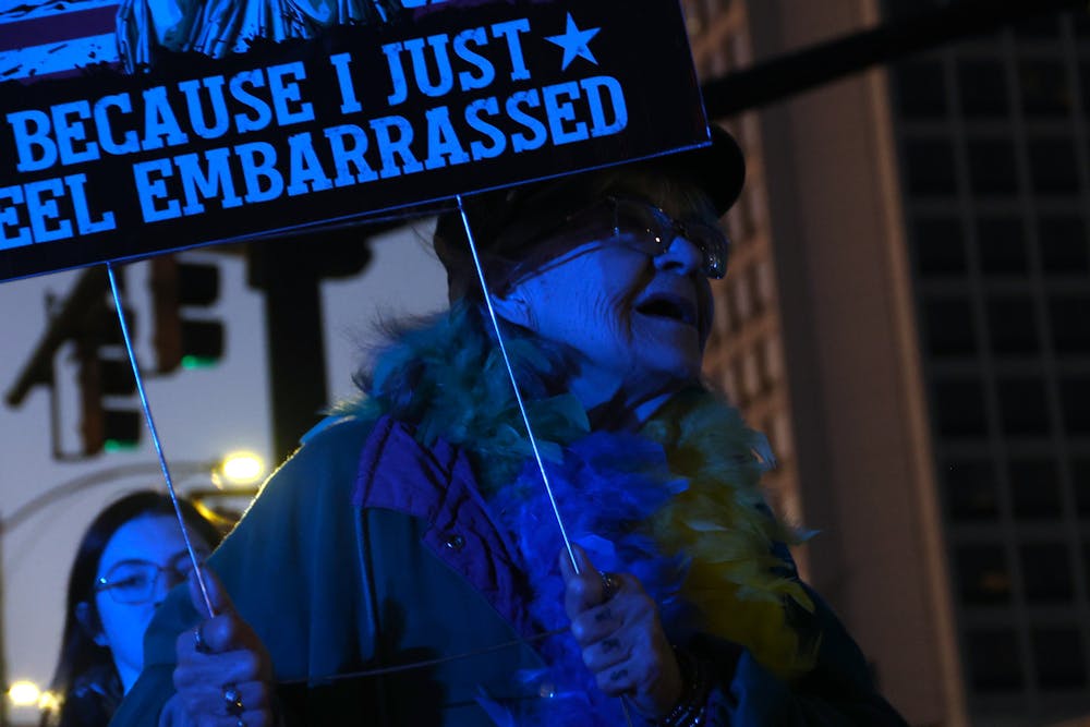 Martha Anderson marches across third street on her way to the William Bootle Federal Building and U.S. Courthouse. “The Constitution has been dismantled, and now they’re killing US citizens in our city streets," Anderson said.
