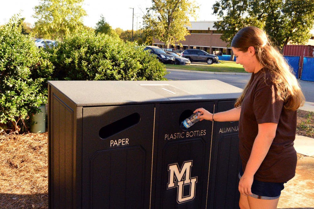  Plunkett RA Lauren Buice using the recycling bin for her hall. 