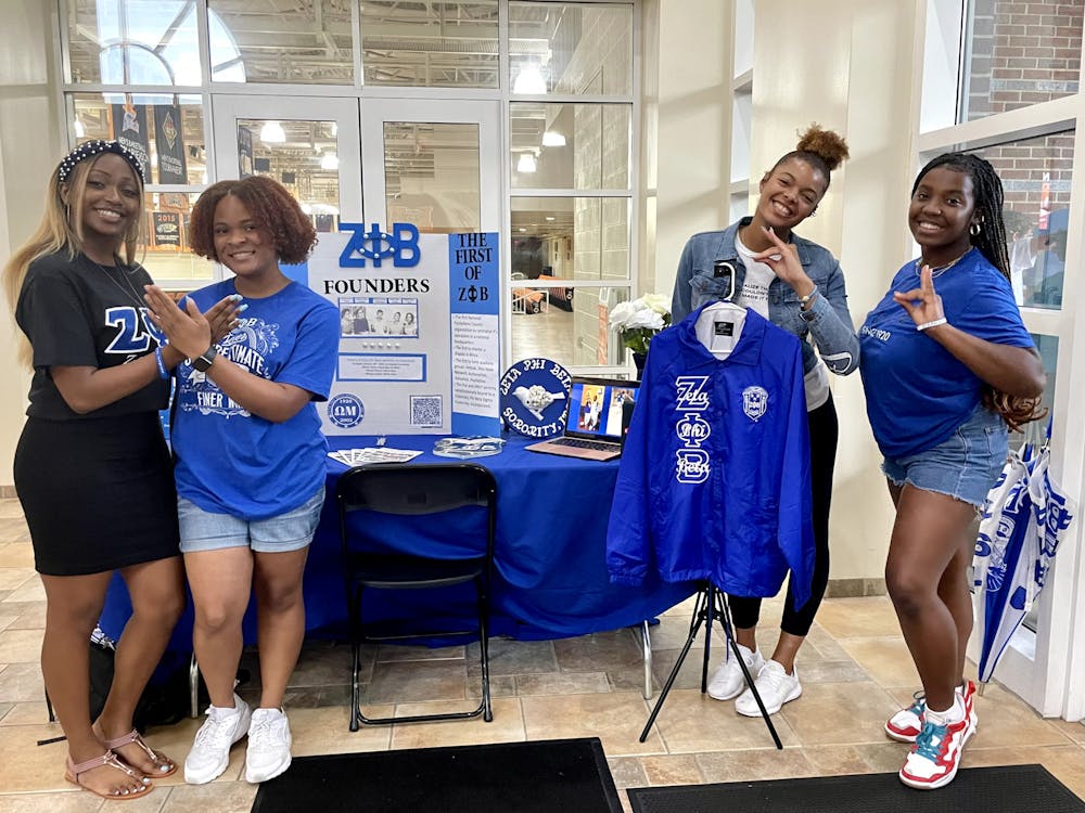 <p>Imira Ackerson, Venicia Twymon, Jaiden Sipe and Ashton Mayo-Beavers pose in front of their booth for Zeta Phi Beta Sorority, Inc. at the Multicultural Mixer.</p>