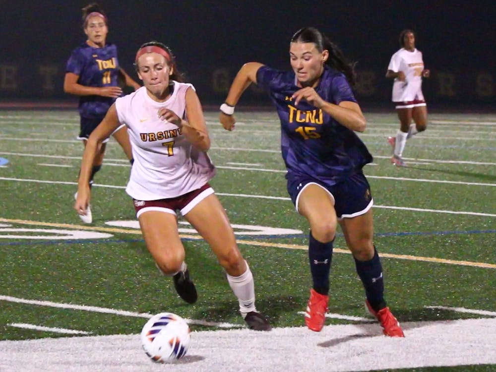 <p><em>Midfielder Jenny Ward charges for the ball to Ursinus defender Lily Ballard. (Photo by Nick Kurti)</em></p>