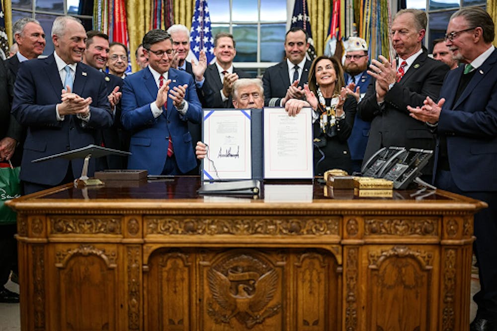 <p><em>President Trump signs the funding bill to end the 43-day government shutdown in the Oval Office. (Photo courtesy of </em><a href="https://commons.wikimedia.org/wiki/File:President_Donald_Trump_shows_members_of_the_media_the_signed_bill_from_Congress_that_reopens_the_government_(54921175496).jpg" target=""><em>Wikimedia Commons</em></a><em>)</em></p>