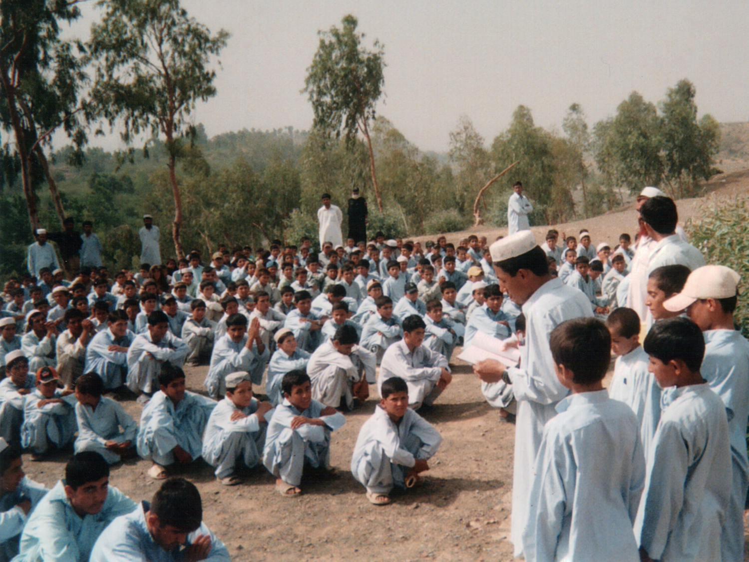 Hundreds of thousands of Afghans are being forced to leave Pakistan as the country implements a nationwide crackdown on all undocumented or unregistered foreigners (Photo courtesy of Wikimedia Commons/“Ahmed Khadr school in Akora Khattak refugee camp” by Ahmed Khadr. September 17, 2008). 