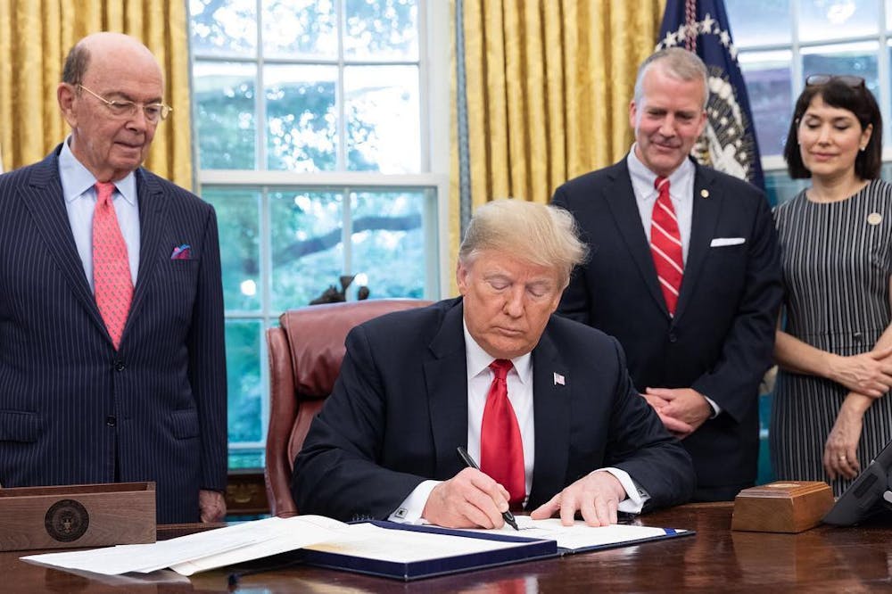 <p><em>President Trump enacts a wave of executive orders reshaping immigration, diversity policies, and more. (Photo courtesy of </em><a href="https://commons.wikimedia.org/wiki/File:Trump_signing_SOS_Act.jpg" target=""><em>Wikimedia Commons</em></a><em> / United States Senate, October 11, 2018)</em></p>