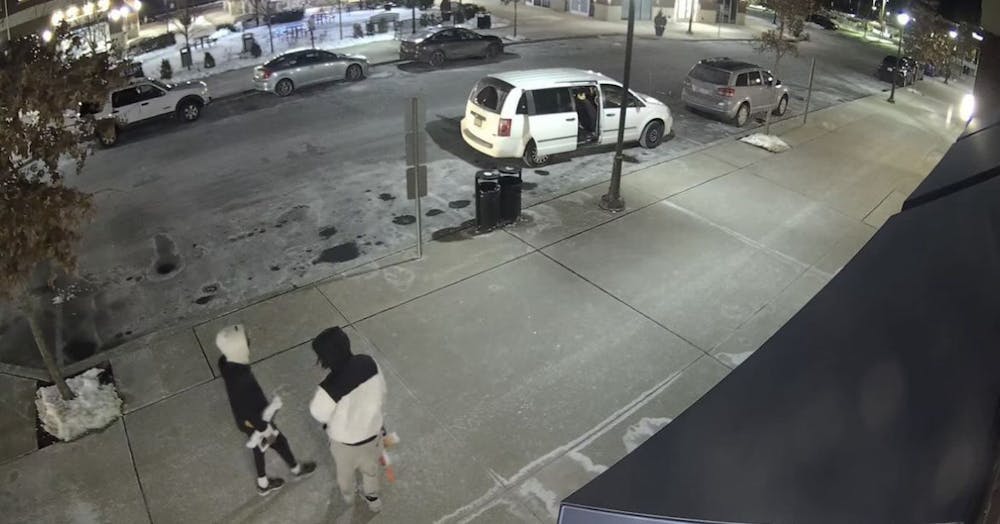 A still from a security camera showing the van and two suspects of the incident (Photo courtesy of Campus Police).