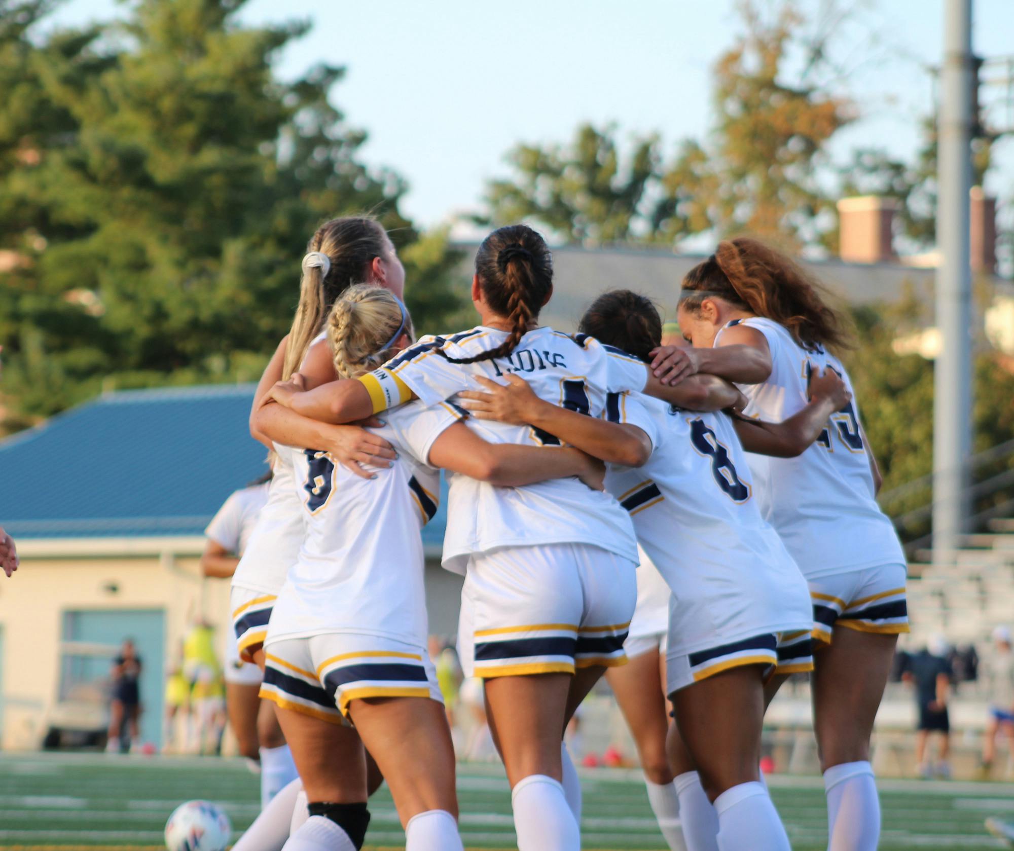 The Lions huddling up (Photo courtesy of Elizabeth Gladstone / Multiamedia Coordinator).