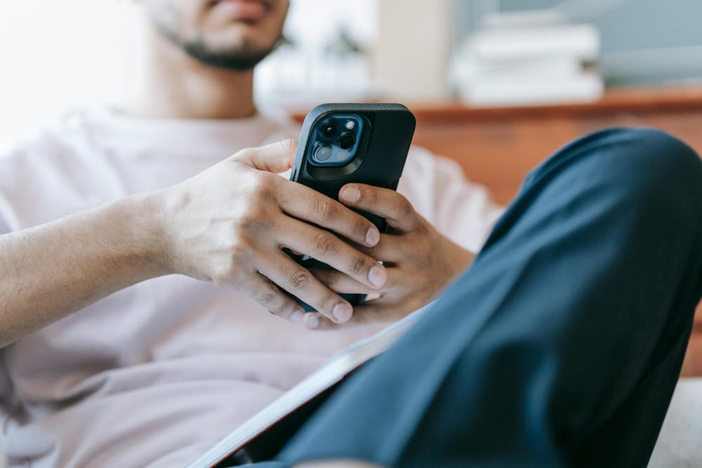 <p><em>Misogynistic content circulates online, impacting schools. (Photo courtesy of </em><a href="https://www.pexels.com/photo/crop-bearded-man-using-smartphone-in-living-room-7129050/" target=""><em>Pexels</em></a><em>) </em></p>