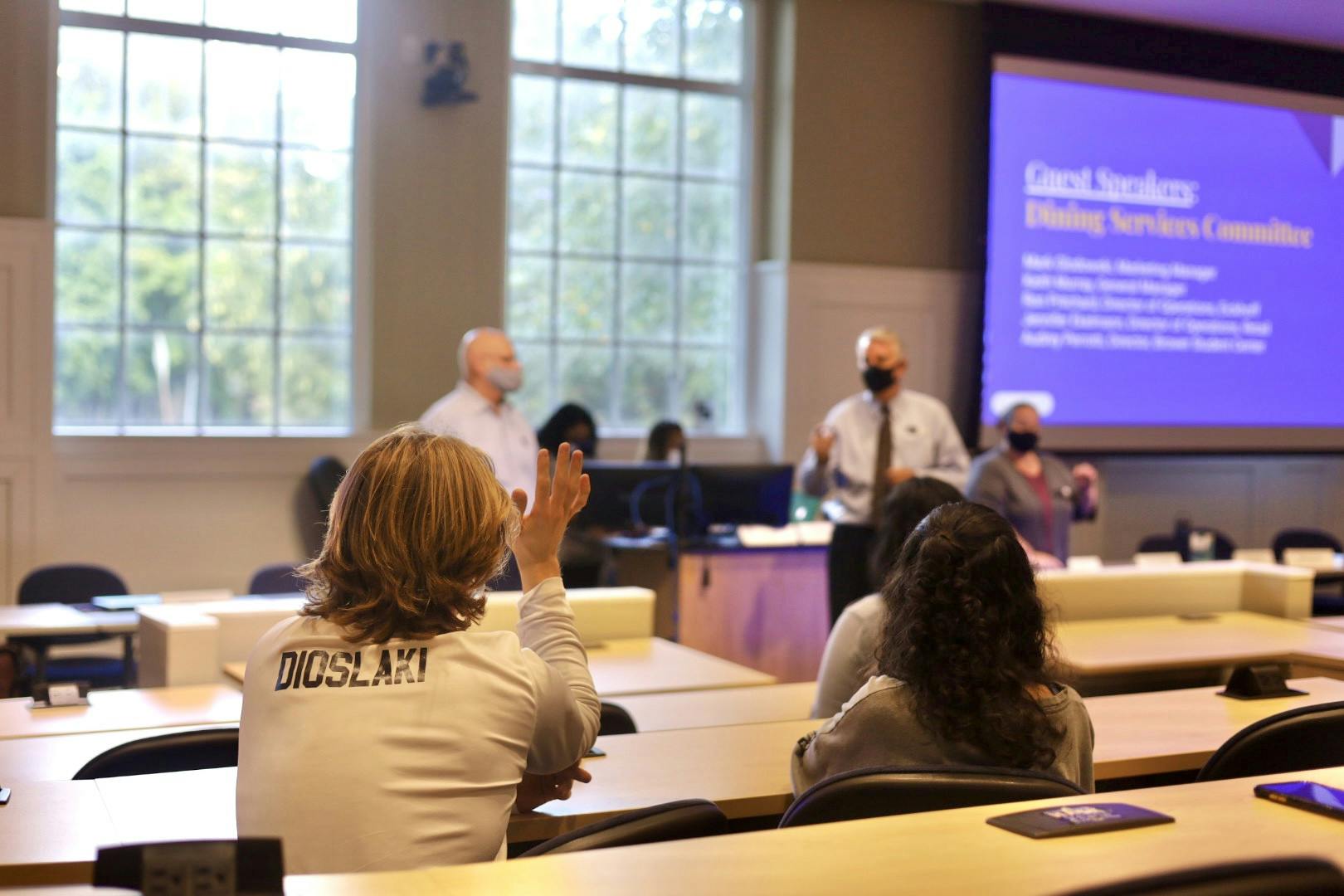 Students raise their hands to ask questions for the dining services committee at the Sept. 29 SG meeting (Kiara Fernandez / Photographer).