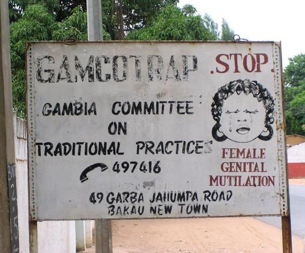 <p><em>Gambian lawmakers ruled on March 18 to advance a measure seeking to overturn the nationwide ban against the practice of female genital cutting (Photo courtesy of </em><a href="https://commons.wikimedia.org/wiki/File:FGM_road_sign,_Bakau,_Gambia,_2005.jpg" target=""><em>Wikimedia Commons</em></a><em> / Nichol Brummer. November 14, 2005). </em></p>