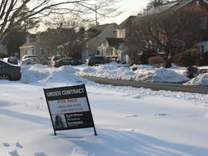 A sale sign is posted in front of a house in a Ewing neighborhood. (Photo by Andre Paras / Video Editor)