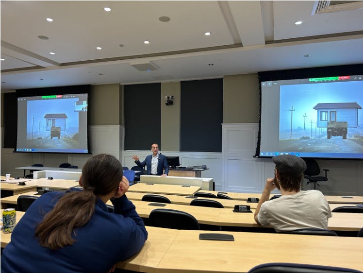 Mouradian with the Associated Press photo symbolizing the Armenians that had to leave their home and continue to be forced to leave through ethnic cleansing (Photo courtesy of Briana Keenan / Staff Writer).