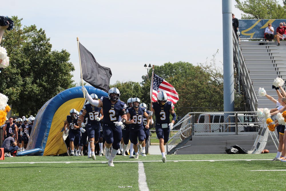 The Lions running out onto the field before their game (Photo courtesy of Elizabeth Gladstone / Multimedia Coordinator). 