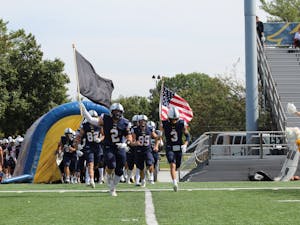 The Lions running out onto the field before their game (Photo courtesy of Elizabeth Gladstone / Multimedia Coordinator). 