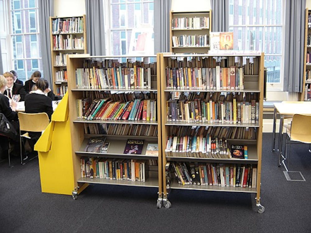 <p><em>The Scholastic Book Fair creates a separate, closable shelf for diverse books. (Photo courtesy of </em><a href="https://commons.wikimedia.org/wiki/File:Library,_Portsmouth_Grammar_School_-_577015741.jpg" target=""><em>Wikimedia Commons</em></a><em> / OP Club Webmaster, Jan. 25, 2007)</em></p>