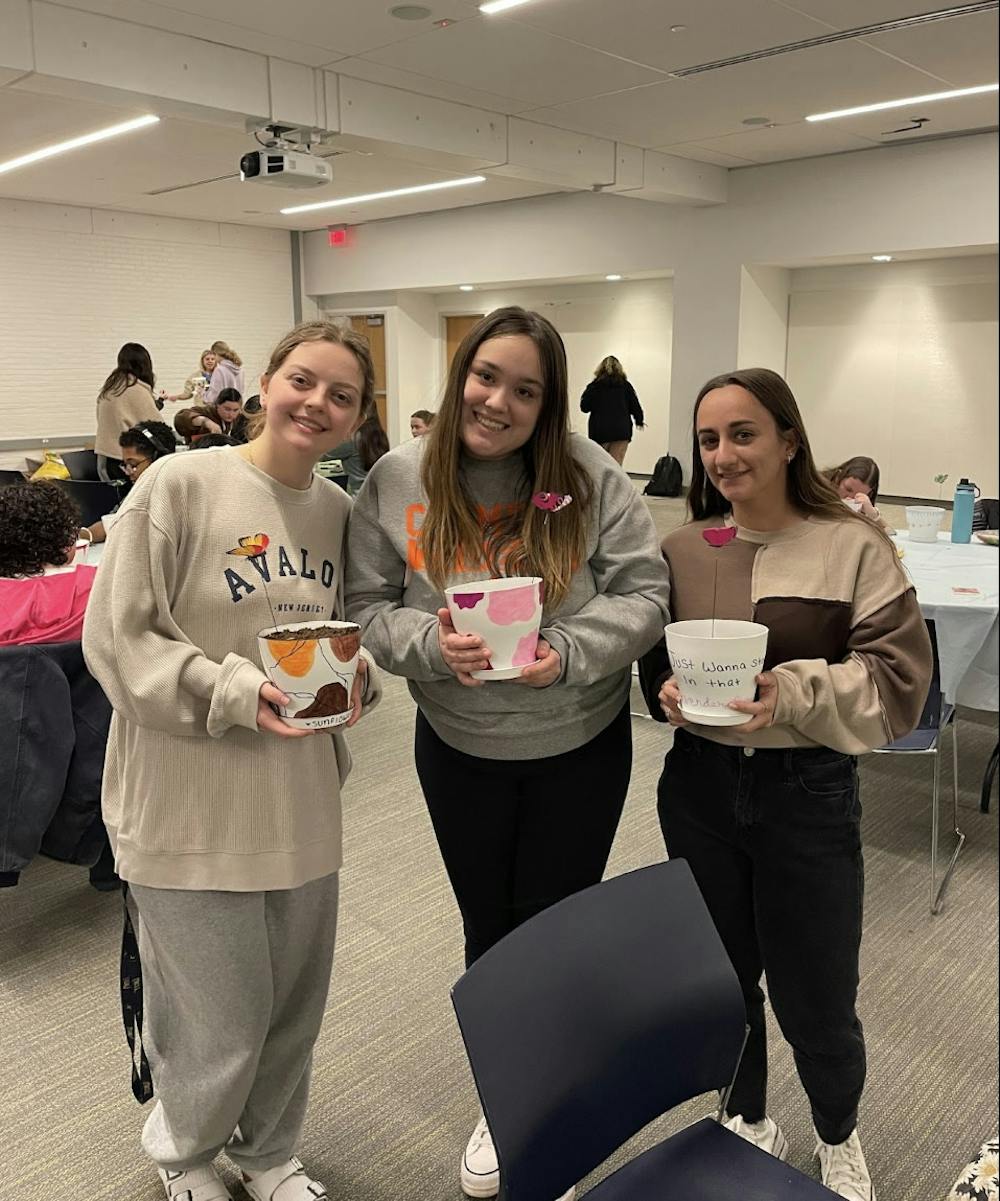 <p>Students pose with their decorated pots (Photo Courtesy of Isabella Darcy / Staff Writer).</p><p><br/><br/><br/></p>