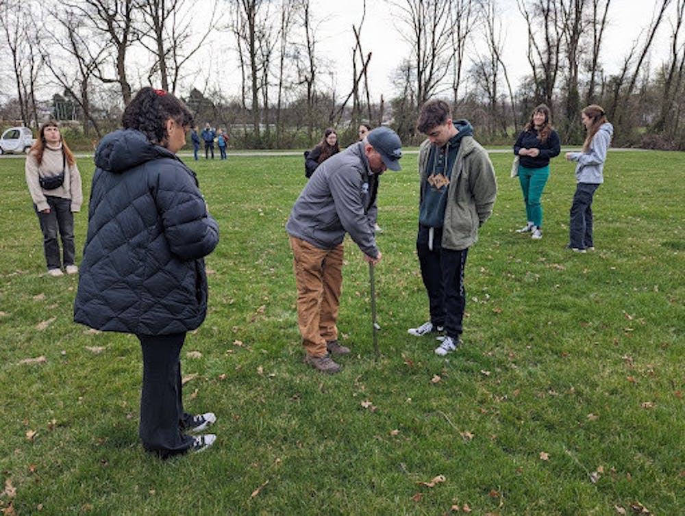 <p><em>TCNJ Organic Land Management students are taught by Richard McCoy, principal owner of Richard A. McCoy Horticultural Services Inc., to take soil samples off the ground at the pilot location (Photo courtesy of Jenna Needham and Maria Hourihan).</em></p>