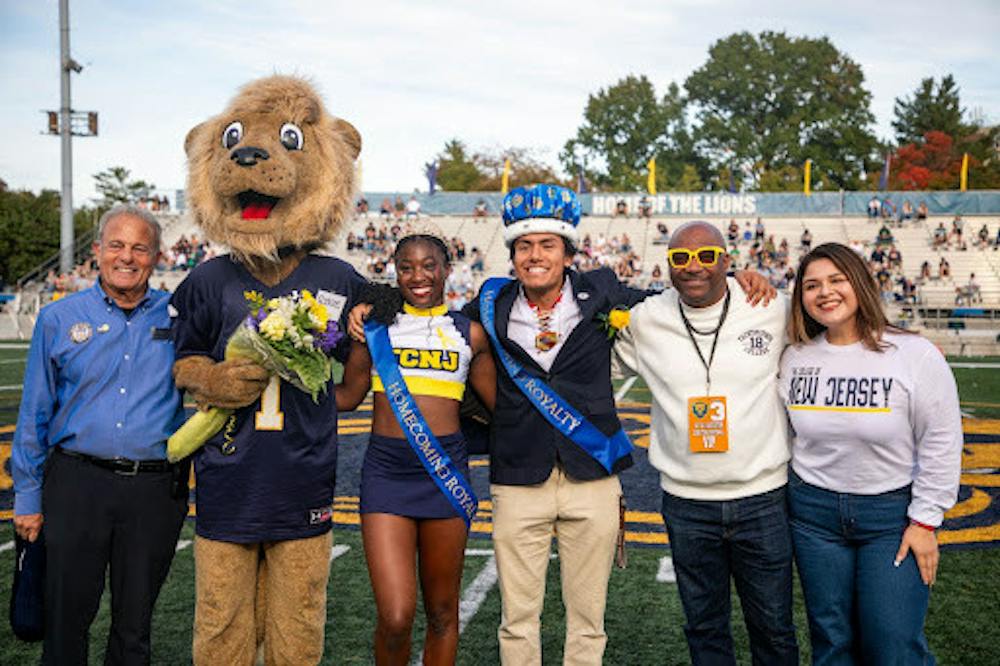 <p><em>2026 Lion Royalty winners Janelle Estime and Estevan Escamilla Zarate pictured alongside Roscoe the Lion and faculty of the College. (Photo by Andre Paras / Managing Editor)</em></p>