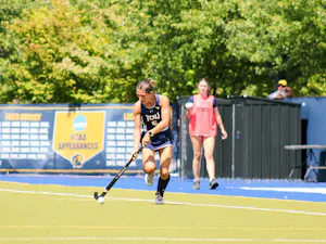 Senior Emma McElroy drives up the field.